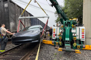 Tesla hit by train lifted crane 2